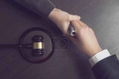 Photo for Top view of a corrupted judge taking a bribe money. Selective focus - Royalty Free Image