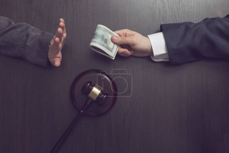 Photo for Top view of a judge refusing a bribery money. Selective focus - Royalty Free Image