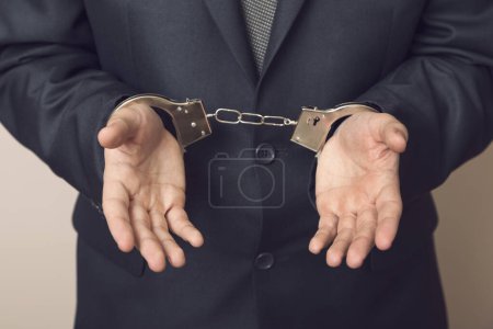 Photo for Businessman in a suit with handcuffs, arrested. Selective focus - Royalty Free Image