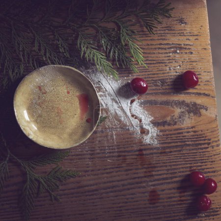Photo for Top view of a rustic kitchen dish on a wooden table with powdered sugar and cherry fruit placed next to it. Selective focus - Royalty Free Image