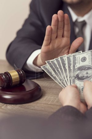 Photo for Detail of a judge refusing a bribery money. Selective focus - Royalty Free Image