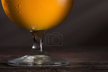 Téléchargez les photos : Gros plan d'un verre mouillé de bière froide légère avec mousse. Concentration sélective - en image libre de droit
