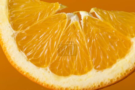 Photo for Close up of an orange slice isolated on orange background - Royalty Free Image