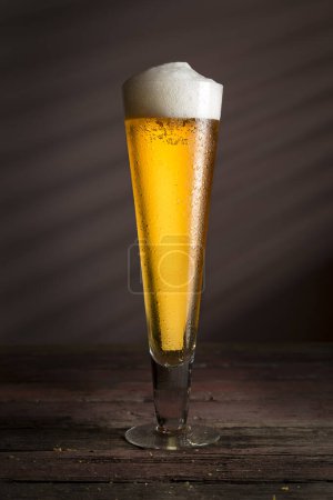 Photo for Glass of cold pale beer on a rustic wooden table - Royalty Free Image
