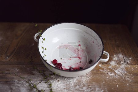 Photo for Rustic kitchen bowl with cherries remaining after making a cherry pie. Selective focus - Royalty Free Image