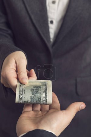 Photo for Corrupted business woman offering money for bribe. Selective focus - Royalty Free Image