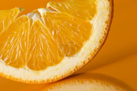 Photo for Studio shot of slice of orange fruit isolated on orange background. Selective focus - Royalty Free Image