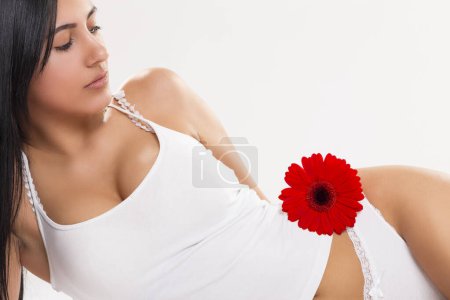 Photo for Beautiful sexy woman with smooth silky skin lying in white underwear isolated on white background - Royalty Free Image
