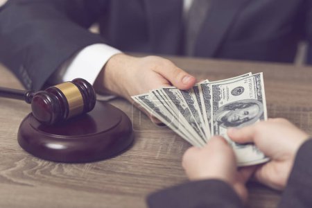 Photo for Detail of a corrupted judge taking a bribe money. Selective focus - Royalty Free Image