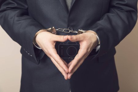 Photo for Businessman in a suit with handcuffs, arrested. Selective focus - Royalty Free Image