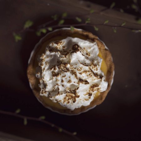 Photo for Top view of an apple tart decorated with whipped cream and cinnamon. Selective focus - Royalty Free Image