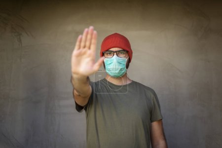 Photo for Man wearing medical face protection mask; air pollution or allergies protection, coronavirus, bacterial and viral respiratory infections prevention and social distancing concept - Royalty Free Image