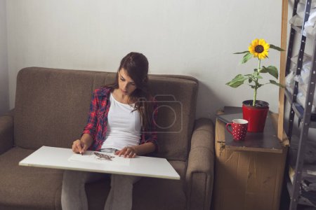 Photo for Young fashion designer making a sketch of a new dress design - Royalty Free Image