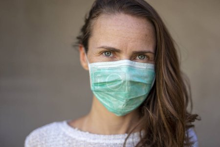 Photo for Woman wearing medical face protection mask; air pollution or allergies protection, coronavirus, bacterial and viral respiratory infections prevention and social distancing concept - Royalty Free Image