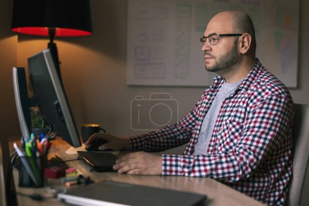 Photo for UX UI designer working on new application development and testing for mobile phone users; freelancer working in home office - Royalty Free Image