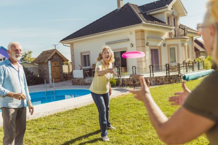 Photo for Group of senior people having fun spending sunny summer day outdoors, playing catch and throw - Royalty Free Image