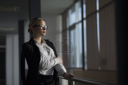 Photo for Strong, confident, business woman standing in an office building hallway - Royalty Free Image