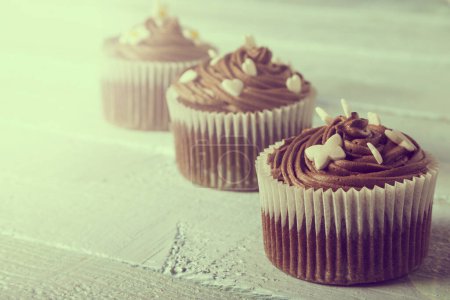Photo for Close up of a nicely decorated chocolate cupcake on a wooden background - Royalty Free Image