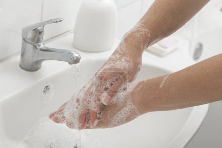 Photo for Close up of a woman washing hands. Selective focus on the hands - Royalty Free Image