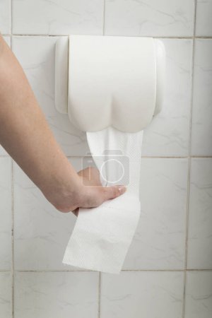 Photo for Detail of a woman's hand using toilet paper - Royalty Free Image