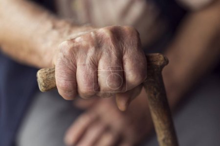 Photo for Detail of an elderly woman's hands holding a cane. Selective focus - Royalty Free Image