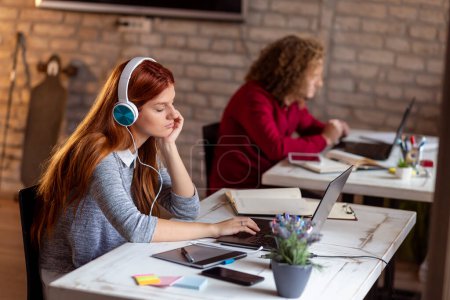 Photo for Web designer working on a new project in a modern coworking space; young business people working in a modern office - Royalty Free Image