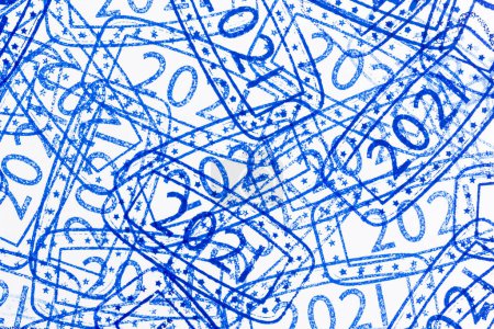 Photo for Detail of ink stamping sheet of paper; close up of bunch of overlaping ink stamps with numbers 2021 representing the upcoming New Year on blank page of paper - Royalty Free Image