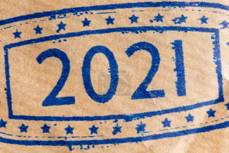 Foto de Detalle de la hoja de estampado de tinta de papel marrón; primer plano del sello de tinta con números 2021 que representa el próximo Año Nuevo en la página de papel marrón - Imagen libre de derechos