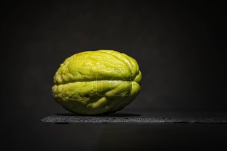 Photo for Close-up of a green squash (chayote) isolated on dark slate background. copy space for text - Royalty Free Image