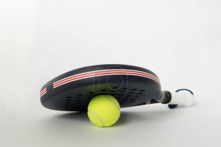 blue professional paddle tennis racket with yellow ball on white background. copy space for text