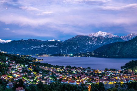 Photo for The panorama of Lake Como photographed from the town of Colonno, at dusk, showing the Northern Grigna, the Southern Grigna, Bellagio, and the town of Colonno. - Royalty Free Image