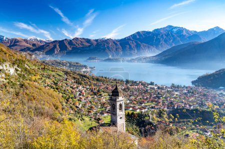 Photo for Lake Como photographed from Ossuccio, showing mountains, Bellagio, the town of Ossuccio, and the Church of the Madonna del Soccorso, in autumn. - Royalty Free Image