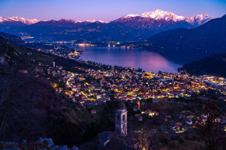 Photo for Panorama of Lake Como from Ossuccio, with Bellagio, the town of Ossuccio, and the Church of the Madonna del Socco, at dusk. - Royalty Free Image