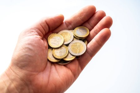 Photo for Hand holding some euro coins. Value of money and prices. - Royalty Free Image