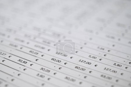 Table with indication of amounts in Euro, and blurred background. Budgets, expenses, earnings.