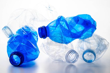 Plastic bottles, blue and transparent, crushed. Waste and plastic pollution, plastic recycling. 