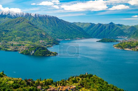 Photo for Lake Como, seen from Perledo, with Varenna, Bellagio, Vezio Castle, Punta Balbianello, on a spring day, with snow-capped mountains. - Royalty Free Image