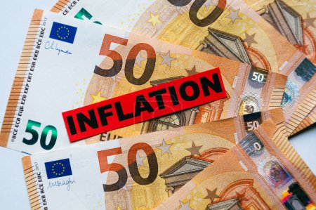 Euro banknotes background, with red ticket with text Inflation.