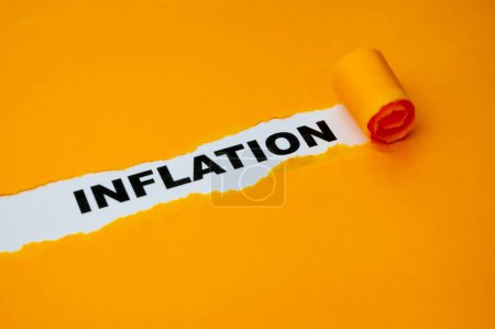 Photo for White surface, with the word Inflation in black, underneath torn and rolled yellow cardboard. - Royalty Free Image