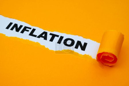 Photo for White surface, with the word Inflation in black, underneath torn and rolled yellow cardboard. - Royalty Free Image