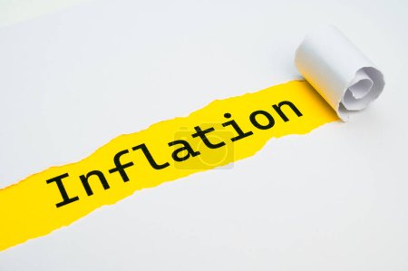 Yellow surface, with the word Inflation in black, underneath torn and rolled white cardboard.