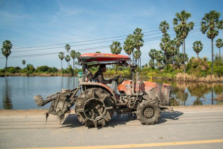 Photo for A Tractor at a Field near the City of Ang Thong in the Province of Ang Thong in Thailand,  Thailand, Ang Thong, November, 2022 - Royalty Free Image
