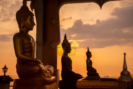 Photo for A buddha at sunset at the Wat Koh Loi at the Koh Loi Island in the City of Si Racha in the Province of Chonburi in Thailand,  Thailand, Siracha, November, 2022 - Royalty Free Image