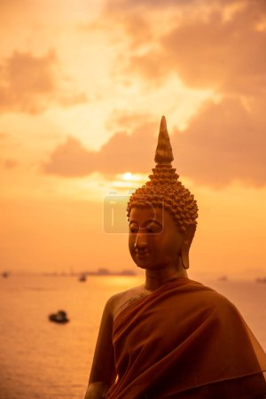 Photo for A buddha at sunset at the Wat Koh Loi at the Koh Loi Island in the City of Si Racha in the Province of Chonburi in Thailand,  Thailand, Siracha, November, 2022 - Royalty Free Image