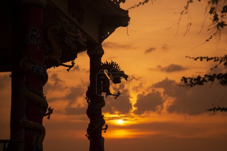 Photo for A dragon at sunset at the Wat Koh Loi at the Koh Loi Island in the City of Si Racha in the Province of Chonburi in Thailand,  Thailand, Siracha, November, 2022 - Royalty Free Image