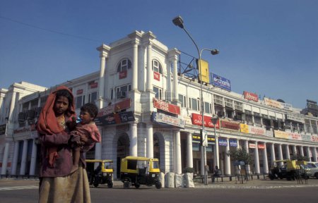 Photo for A poor women with child at the shopping area of Connaught Place in the city of New Delhi in India.  India, Delhi, Februar, 1998 - Royalty Free Image