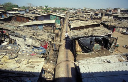 Photo for A water Pipeline in the centre of a slum in the city centre of Mumbai in India.  India, Mumbai, March, 1998 - Royalty Free Image