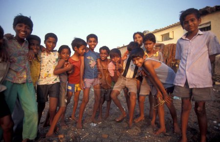 Photo for A Indian Family in a village centre of a slum in the city centre of Mumbai in India.  India, Mumbai, March, 1998 - Royalty Free Image