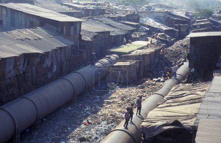 Photo for A water Pipeline in the centre of a slum in the city centre of Mumbai in India.  India, Mumbai, March, 1998 - Royalty Free Image
