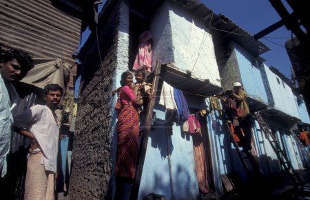Photo for People and daily life at a village centre of a slum in the city centre of Mumbai in India.  India, Mumbai, March, 1998 - Royalty Free Image